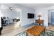 Open living area with a large screen TV, laminate flooring, and blue wall trim at 215 Piedmont Ne Ave # 2208, Atlanta, GA 30308
