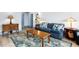 Comfortable living room with a blue sofa, patterned rug, and wood coffee table at 215 Piedmont Ne Ave # 2208, Atlanta, GA 30308