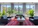 Inviting lobby with comfortable seating, lush plants, and large windows showcasing natural light at 215 Piedmont Ne Ave # 2208, Atlanta, GA 30308