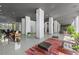 Spacious lobby with modern decor, columns, stylish lighting, and comfortable seating areas at 215 Piedmont Ne Ave # 2208, Atlanta, GA 30308