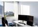 Office space with a skyline view, adjustable desk, laminate flooring, and modern chair at 215 Piedmont Ne Ave # 2208, Atlanta, GA 30308