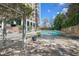 Community pool area with seating, landscaping, and shade, ideal for relaxation and social gatherings at 215 Piedmont Ne Ave # 2208, Atlanta, GA 30308