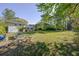 Spacious backyard with lush lawn, garden beds, and a glimpse of the two-story house at 2637 Elkhorn Dr, Decatur, GA 30034