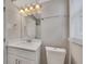 Bright bathroom featuring a white vanity with a quartz countertop and modern lighting at 2637 Elkhorn Dr, Decatur, GA 30034