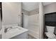 Modern bathroom with a stylish vanity, shower, tub, and sleek black shelving at 2637 Elkhorn Dr, Decatur, GA 30034