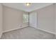 Bedroom with carpet, a window, and a closet at 2637 Elkhorn Dr, Decatur, GA 30034