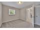 Neutral bedroom with carpeted floors, window, white trim, and open doorway at 2637 Elkhorn Dr, Decatur, GA 30034