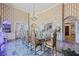 Grand dining area with a glass table, carved wood chairs, decorative wallpaper, and access to other rooms at 3000 Cathedral Place Pl, Decatur, GA 30034