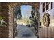 Arched stone doorway reveals a serene garden, promising a unique and enchanting home experience at 3000 Cathedral Place Pl, Decatur, GA 30034