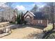 Charming two-story home with a Tudor design featuring stone facade and well-manicured front yard at 3000 Cathedral Place Pl, Decatur, GA 30034