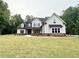 Beautifully landscaped two-story home with stone accents, dormer windows, and a welcoming front yard at 169 West Lake Blvd, Carrollton, GA 30116