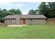 Expansive backyard featuring a well-maintained lawn, patio area, garden space, and privacy fencing at 199 Candy Ln, Canton, GA 30115