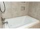 Modern bathtub with tile surround and fixtures at 199 Candy Ln, Canton, GA 30115