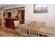 Open dining area with a wooden table set, open to a kitchen with granite counter and stainless appliances at 199 Candy Ln, Canton, GA 30115
