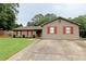 Traditional home showcasing red shutters, fresh landscaping, and a well-maintained lawn for a classic curb appeal at 199 Candy Ln, Canton, GA 30115