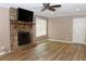 Cozy living room features a stone fireplace and hardwood flooring at 199 Candy Ln, Canton, GA 30115