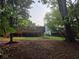 Expansive wooden deck in a backyard surrounded by mature trees and landscaping at 2413 N. Decatur Rd, Decatur, GA 30033