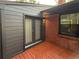 Backyard exterior showcasing a deck, black siding and brick, with access via glass doors at 2413 N. Decatur Rd, Decatur, GA 30033
