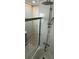 Shower with dual fixtures, tile walls and glass partition plus grey vanity in neutral bathroom at 2413 N. Decatur Rd, Decatur, GA 30033