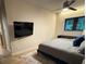 Modern bedroom with a comfortable bed, large window, ceiling fan and wall mounted TV at 2413 N. Decatur Rd, Decatur, GA 30033