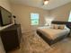 Cozy bedroom featuring a queen bed with storage, a modern dresser, and a window overlooking the yard at 2413 N. Decatur Rd, Decatur, GA 30033