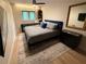 Stylish bedroom featuring a comfortable queen bed, sleek furniture, and a bright window at 2413 N. Decatur Rd, Decatur, GA 30033