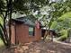 Charming brick home with a flag on display with mature trees and landscaping at 2413 N. Decatur Rd, Decatur, GA 30033