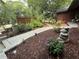 Beautifully landscaped front yard featuring a stone pathway, stacked stone, and vibrant purple flowers at 2413 N. Decatur Rd, Decatur, GA 30033