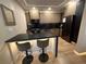 Stylish kitchen featuring modern cabinetry, stainless steel appliances, and a breakfast bar with seating at 2413 N. Decatur Rd, Decatur, GA 30033