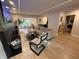 Bright living room with fireplace, hardwood floors, modern lighting and view of dining area at 2413 N. Decatur Rd, Decatur, GA 30033