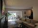 Cozy living room featuring a comfortable sectional sofa, open to the dining area for seamless entertaining at 2413 N. Decatur Rd, Decatur, GA 30033