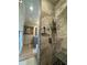 Luxurious shower with a marble surround, a bench, multiple shower heads, and a glass partition at 2413 N. Decatur Rd, Decatur, GA 30033