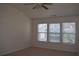 Bright bedroom with neutral walls, three windows and ceiling fan providing ample natural light at 2955 Briaroak Dr, Duluth, GA 30096