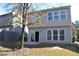 Back exterior featuring a sliding glass door and windows on the second floor at 2955 Briaroak Dr, Duluth, GA 30096
