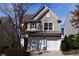 Charming two-story home with a two-car garage and neutral siding, surrounded by lush landscaping at 2955 Briaroak Dr, Duluth, GA 30096