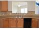 Kitchen with wood cabinets, a stainless steel sink, black appliances and tile backsplash at 2955 Briaroak Dr, Duluth, GA 30096