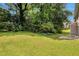 Spacious backyard with lush green grass and neutral siding at 4879 Ardsley Dr, Lithonia, GA 30038