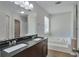 This sleek bathroom has dual sinks, a soaking tub and modern fixtures at 4879 Ardsley Dr, Lithonia, GA 30038