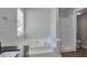 This bright bathroom features a soaking tub, a separate shower and good lighting at 4879 Ardsley Dr, Lithonia, GA 30038