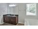 This relaxing bathroom features a double sink vanity, soaking tub and natural light at 4879 Ardsley Dr, Lithonia, GA 30038