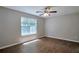 This cozy bedroom features new floors, a ceiling fan and a sunny window at 4879 Ardsley Dr, Lithonia, GA 30038