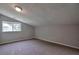 Angled room with a window, neutral walls, and soft carpet at 4879 Ardsley Dr, Lithonia, GA 30038