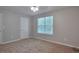 This bedroom features neutral walls, soft carpet, and a bright window at 4879 Ardsley Dr, Lithonia, GA 30038