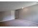 Neutral, angled room with soft carpet and two doors at 4879 Ardsley Dr, Lithonia, GA 30038
