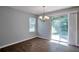 Dining area with hardwood floors, chandelier, and a view of the backyard at 4879 Ardsley Dr, Lithonia, GA 30038