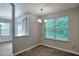 Cozy dining area with hardwood floors, a chandelier, and a large window at 4879 Ardsley Dr, Lithonia, GA 30038