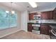 Modern kitchen with stainless steel appliances, dark cabinets, and a window at 4879 Ardsley Dr, Lithonia, GA 30038