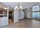 Living room features hardwood floors, a fireplace, and stairs leading to the second floor and connecting to the kitchen at 4879 Ardsley Dr, Lithonia, GA 30038