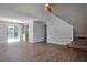 Open-concept living room with hardwood floors, sliding glass doors, and stairs leading to the second floor at 4879 Ardsley Dr, Lithonia, GA 30038