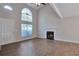 Inviting living room features a fireplace, large window, and a ceiling fan at 4879 Ardsley Dr, Lithonia, GA 30038